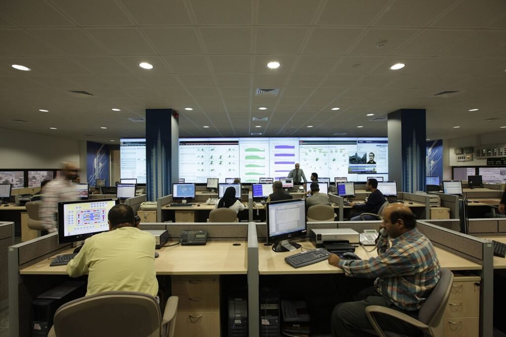 Cyber security operations centre with analysts monitoring screens