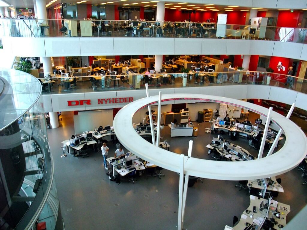 Newsrooms Test AI Deepfake Detection Under Deadline Journalists working in a newsroom
