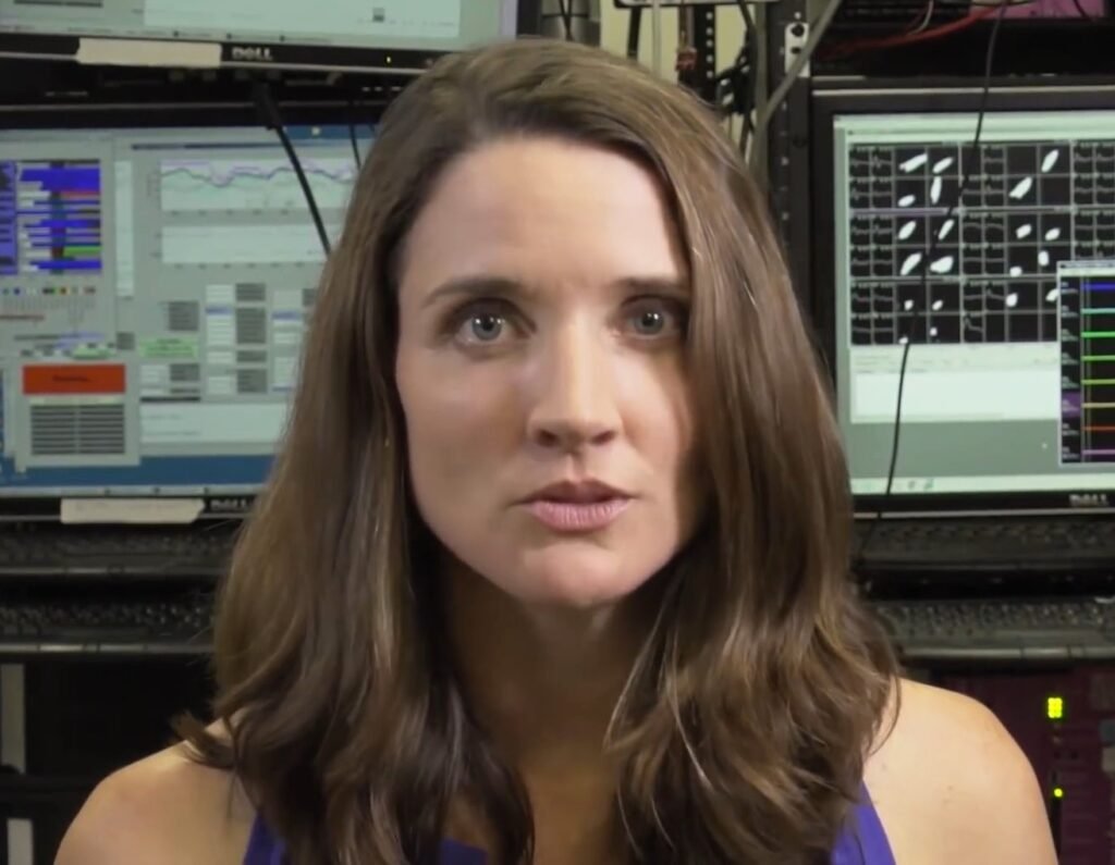 Brain-Computer Interfaces Move From Spectacle to Clinical Work A researcher studying brain activity scans on a monitor